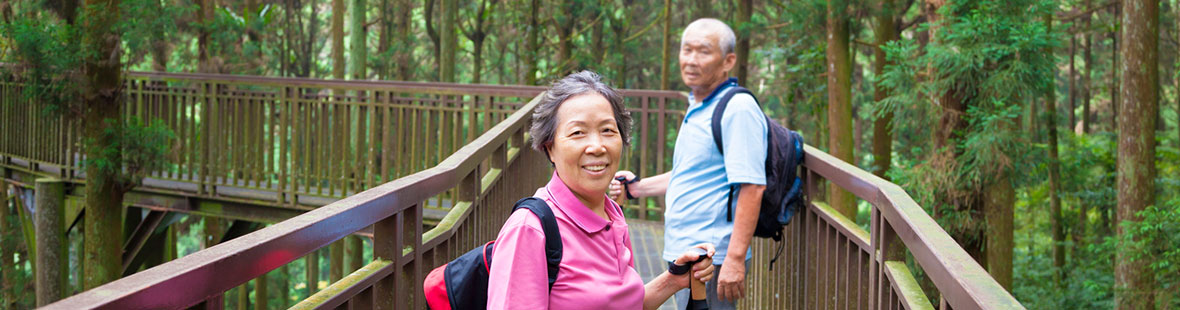 Couple walking on wooded trail